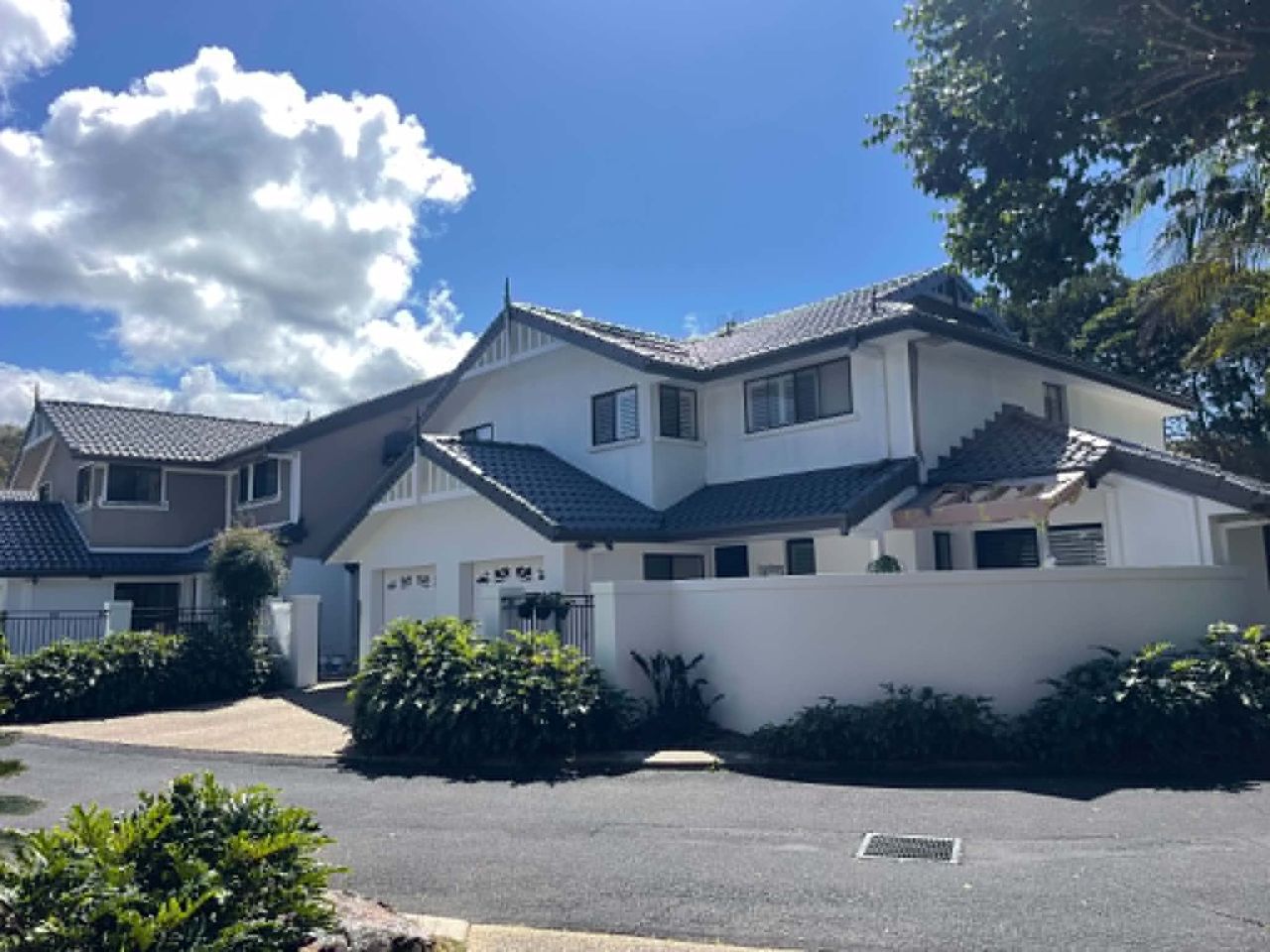 Rendered home after repaint with grey roof