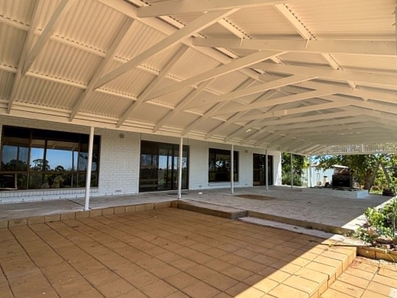 Covered patio after painting, cream ceiling and white walls