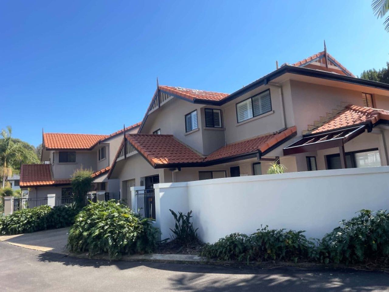 Rendered home before repaint with terracotta roof