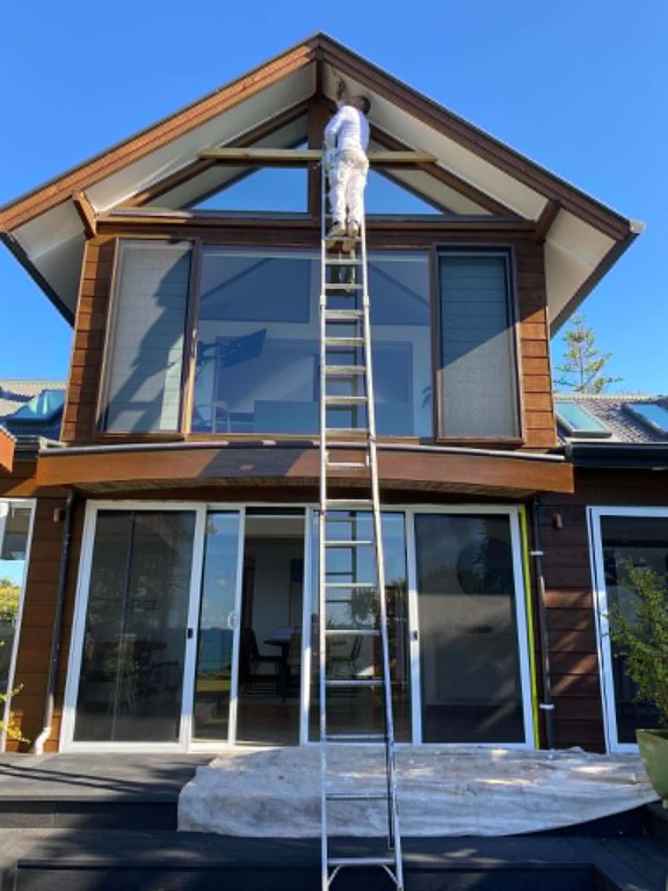 Painter working at height on a ladder